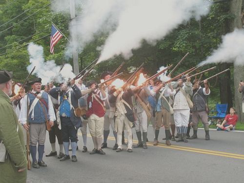 Sudbury Companies of Militia and Minute firing a musket salute during 2012 Sudbury Fourth of July parade