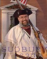 Member of the Sudbury militia at entrance to Wayside Inn